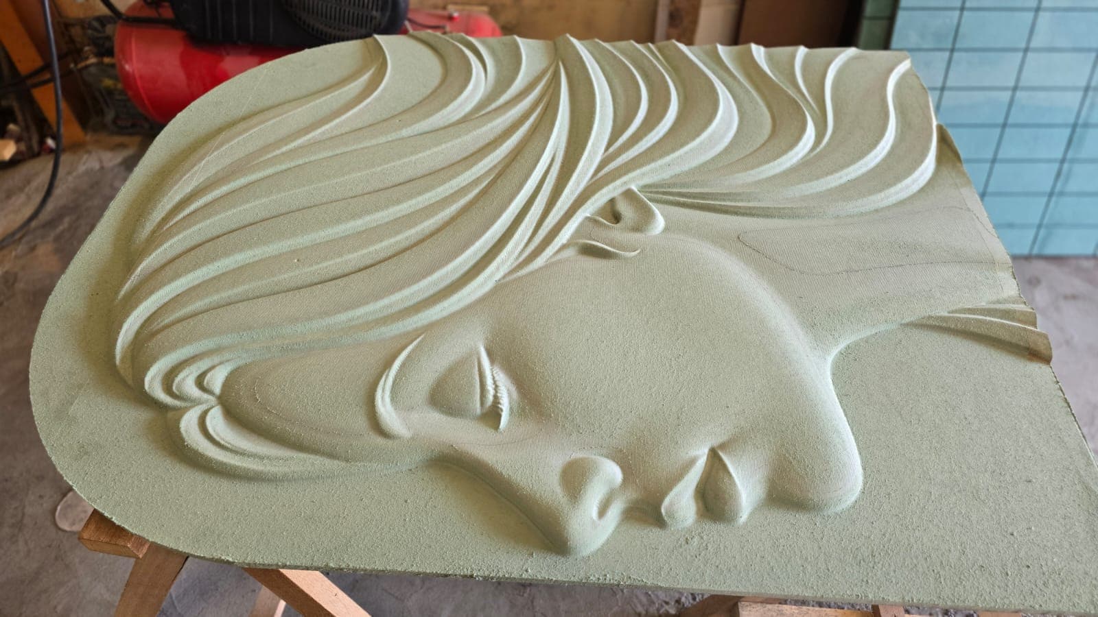 Close-up of an organic parametric relief sculpture in progress — flowing curved forms hand-finished after CNC machining at Dervano Studio.